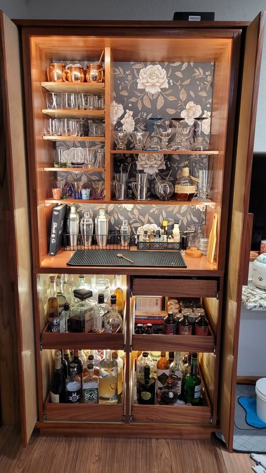 Custom build-to-order liquor cabinet in sapele with lit pocket doors and hand-made drawers