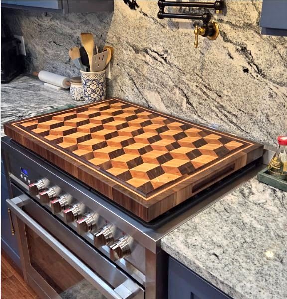 End-grain butcher block with a 3D tumbling-block marquetry pattern in walnut, maple and cherry